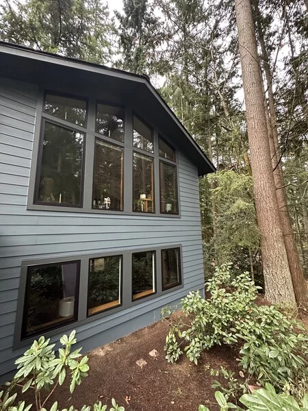 Seattle home exterior in heavy fall rain — why fall and winter painting fails in Pacific Northwest