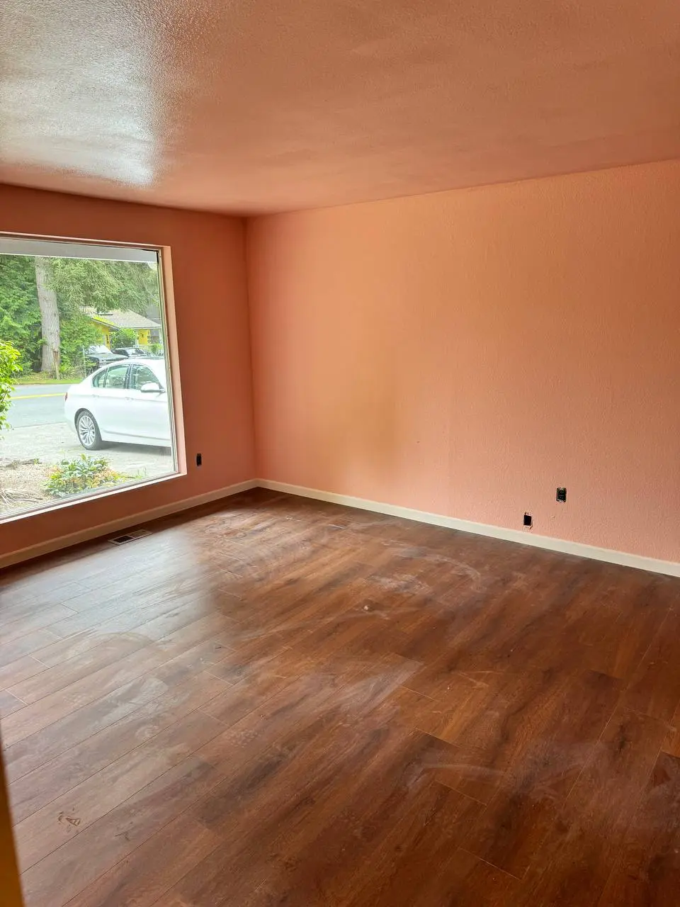 Bold orange interior painting in bedroom with natural lighting in Shoreline home