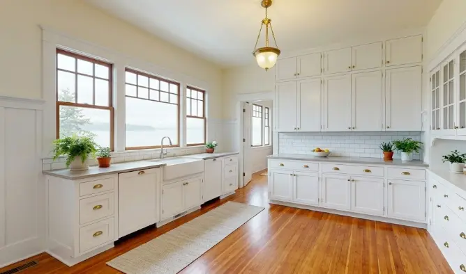Freshly painted bright kitchen interior in an Edmonds Washington home showing clean white walls, painted cabinets and crisp trim with natural light
