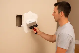 Large drywall hole repair in Bothell home showing seamless patch