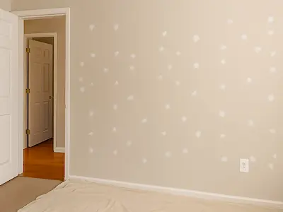 Wall patching for move-out preparation in Bothell home showing multiple nail holes being repaired